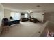 Spacious living room with carpet flooring, a ceiling fan, and multiple sofas at 211 Hunt St, Clermont, FL 34711
