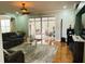 A cozy living room with plush seating, glass coffee table and hardwood floors at 211 Hunt St, Clermont, FL 34711