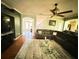 Comfortable living room features a ceiling fan, hardwood floors, and a modern area rug at 211 Hunt St, Clermont, FL 34711
