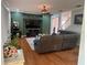 Inviting living room boasts hardwood floors, a ceiling fan, and a large sectional sofa at 211 Hunt St, Clermont, FL 34711