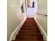 Staircase with hardwood steps and white railings leads to a bright and inviting home interior at 211 Hunt St, Clermont, FL 34711