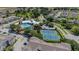 Aerial view of a swimming pool, tennis courts, and surrounding homes in a landscaped community at 2304 Silver Palm Dr # 304, Kissimmee, FL 34747
