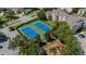 Aerial shot of tennis courts and playground adjacent to apartments, trees, and landscaping at 2304 Silver Palm Dr # 304, Kissimmee, FL 34747