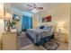 Comfortable bedroom with blue accents, a ceiling fan and television for relaxing evenings at 2304 Silver Palm Dr # 304, Kissimmee, FL 34747
