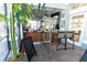 Outdoor bar area with bar stools, a chalkboard menu, and tropical plants for an island vibe at 2304 Silver Palm Dr # 304, Kissimmee, FL 34747