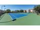 Well-maintained community tennis courts with blue playing surface, surrounded by green space and fencing at 2304 Silver Palm Dr # 304, Kissimmee, FL 34747