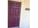 A classic burgundy-colored front door with an address plate on the side, creating an inviting entrance to the home at 2882 Club Cortile Cir # B, Kissimmee, FL 34746