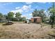 Large backyard featuring storage shed, trampoline, and grill area provides ample space for outdoor activities and entertainment at 2921 Bon Air Dr, Orlando, FL 32818
