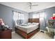 Cozy bedroom featuring neutral walls, tiled floor, ceiling fan and natural light at 2921 Bon Air Dr, Orlando, FL 32818