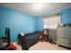 Bedroom with blue walls, tiled floor, and closet at 2921 Bon Air Dr, Orlando, FL 32818