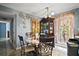 Bright dining area with round table, display cabinet, and large window at 2921 Bon Air Dr, Orlando, FL 32818
