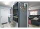 Modern kitchen featuring stainless steel refrigerator and easy access to the living room at 2921 Bon Air Dr, Orlando, FL 32818
