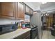 Galley kitchen with stainless steel appliances and tiled floor at 2921 Bon Air Dr, Orlando, FL 32818