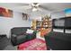 A cozy living room features comfortable seating, a ceiling fan, and a red rug at 2921 Bon Air Dr, Orlando, FL 32818