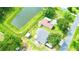 Aerial view of a property with a pond, showcasing its layout and surrounding greenery at 2932 Larson St, Kissimmee, FL 34741