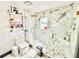 Bright bathroom featuring marble floors and walls, floating shelves and glass shower with gold fixtures at 2932 Larson St, Kissimmee, FL 34741