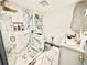 Bright bathroom featuring marble floors and walls, gray cabinets with gold hardware and glass shower at 2932 Larson St, Kissimmee, FL 34741