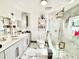 Bright bathroom featuring marble floors and walls, double vanity and a glass shower with gold fixtures at 2932 Larson St, Kissimmee, FL 34741