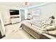 Bright bedroom with a ceiling fan, white dresser, and a television mounted on the wall at 2932 Larson St, Kissimmee, FL 34741