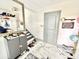 Open entryway with stylish marble floors, storage cabinet, and staircase to the upper level at 2932 Larson St, Kissimmee, FL 34741