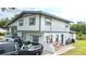 Rear exterior view featuring a split level home with a white and grey color scheme at 2932 Larson St, Kissimmee, FL 34741