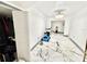 Long hallway with attractive marble flooring and a closet, illuminated by a modern light fixture at 2932 Larson St, Kissimmee, FL 34741