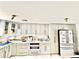 Well-equipped kitchen with white cabinets and countertops and stainless steel appliances at 2932 Larson St, Kissimmee, FL 34741