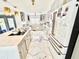 Bright kitchen with white cabinets, marble floors, and a modern, stainless steel refrigerator at 2932 Larson St, Kissimmee, FL 34741