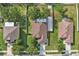 Aerial view highlights backyard with white fence, patio space, and mature trees at 2950 Inca Ave, Clermont, FL 34715