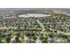 Aerial view showcasing the community's lush greenery, serene lake, and picturesque neighborhood layout at 2950 Inca Ave, Clermont, FL 34715