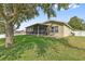 Spacious backyard with a screened-in porch and a patio area, perfect for outdoor living and entertaining at 2950 Inca Ave, Clermont, FL 34715