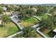 Aerial view of a backyard featuring a white fence, lush lawn, and a private patio space at 2950 Inca Ave, Clermont, FL 34715