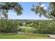 Scenic backyard view overlooking the neighborhood, featuring lush greenery and an elegant wrought iron fence at 2950 Inca Ave, Clermont, FL 34715