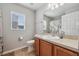 Bright bathroom with a large mirror and wooden vanity at 2950 Inca Ave, Clermont, FL 34715