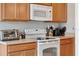 Bright kitchen with wooden cabinets, white appliances, and light countertops at 2950 Inca Ave, Clermont, FL 34715