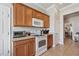Bright kitchen featuring wooden cabinets, neutral countertops, and a view into the dining and living areas at 2950 Inca Ave, Clermont, FL 34715
