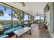 Relaxing screened-in patio with comfortable seating, a grill, and scenic views at 2950 Inca Ave, Clermont, FL 34715