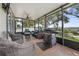 Beautiful screened patio featuring outdoor furniture, grill, and stunning landscape at 2950 Inca Ave, Clermont, FL 34715
