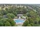 Aerial view of a community pool surrounded by lush greenery and neighborhood homes at 2950 Inca Ave, Clermont, FL 34715
