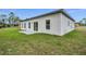 Exterior back view of home featuring sliding glass doors and green backyard at 357 Marion Oaks Pass, Ocala, FL 34473