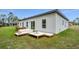 Wide view of backyard staging featuring lounge furniture and a view of home's windows and doors at 357 Marion Oaks Pass, Ocala, FL 34473