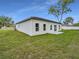 Backyard exterior shows a freshly painted home with a bright green lawn at 357 Marion Oaks Pass, Ocala, FL 34473