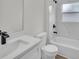 Clean bathroom featuring white fixtures, modern faucet, marble wall tiles, and natural light at 357 Marion Oaks Pass, Ocala, FL 34473