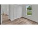 Bright bedroom with hardwood floors, closet and a window overlooking the neighborhood at 357 Marion Oaks Pass, Ocala, FL 34473