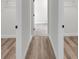 Spacious walk-in closet with dual access, wood-look flooring, and ample shelving for storage at 357 Marion Oaks Pass, Ocala, FL 34473
