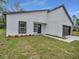 New construction home featuring dark trim, a simple landscaping design, and freshly cut lawn at 357 Marion Oaks Pass, Ocala, FL 34473