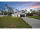 New construction home with dark grey accents, black garage door and green grass in the yard at 357 Marion Oaks Pass, Ocala, FL 34473