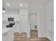 Bright kitchen featuring white cabinetry, stainless steel appliances, and modern pendant lighting at 357 Marion Oaks Pass, Ocala, FL 34473