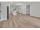 Open-concept living room with hardwood floors, flowing into kitchen with an island and modern appliances at 357 Marion Oaks Pass, Ocala, FL 34473