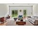 Bright living room featuring hardwood floors, large windows, and modern furniture at 357 Marion Oaks Pass, Ocala, FL 34473
